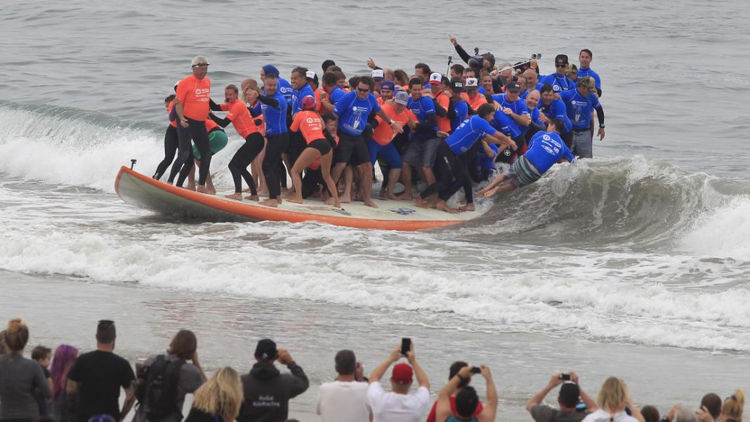 world's largest surfboard ridden by the most number of people ever blank